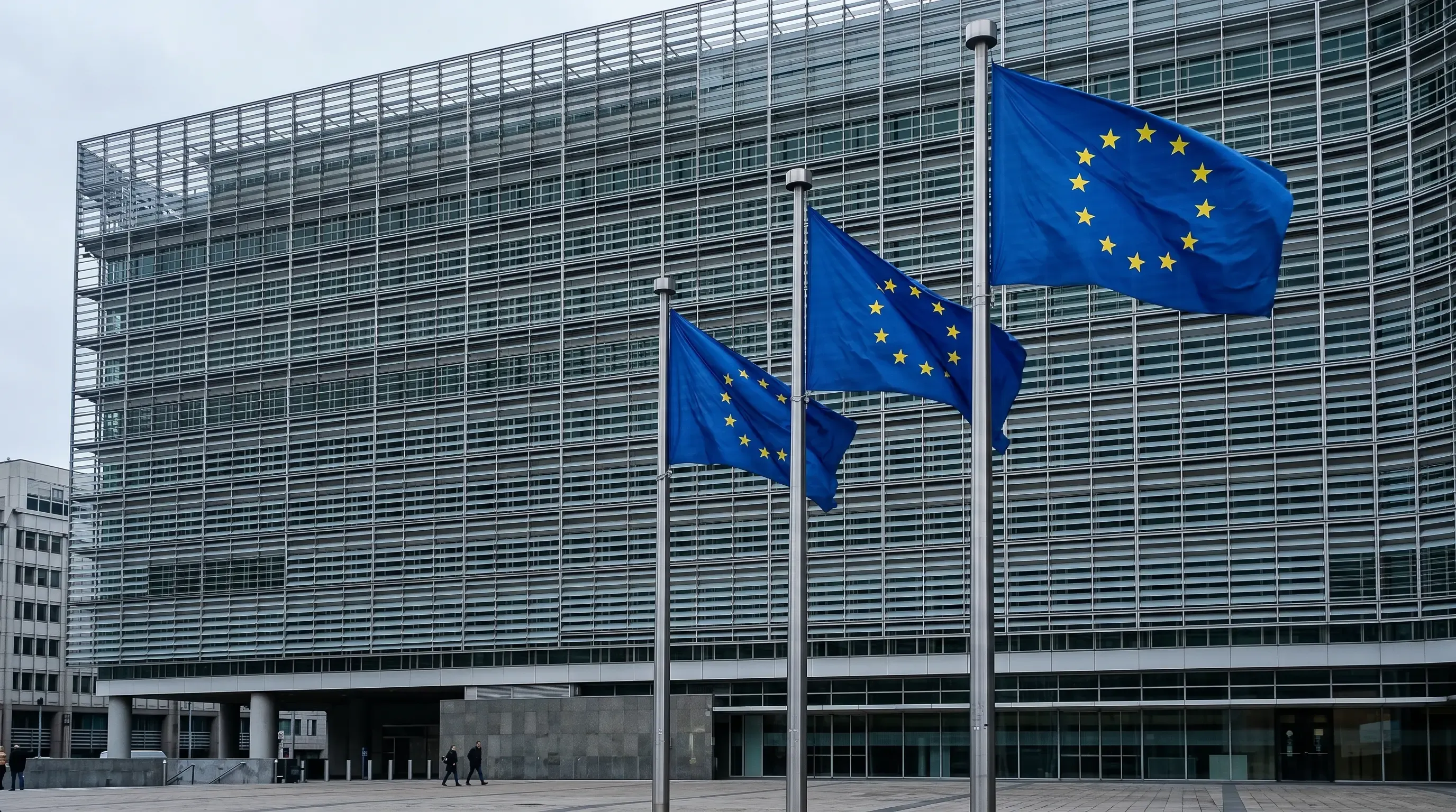 An image of a building in Brussels with EU flags waving next to it