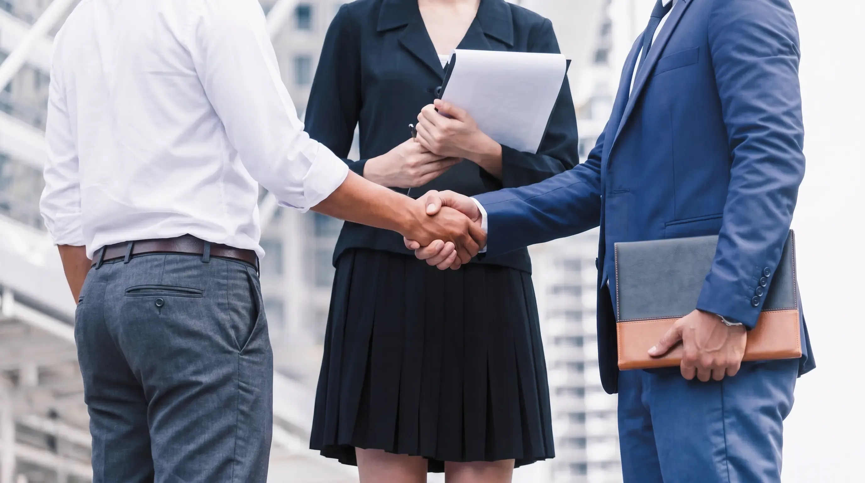 An image of two well-dressed professionals shaking hands