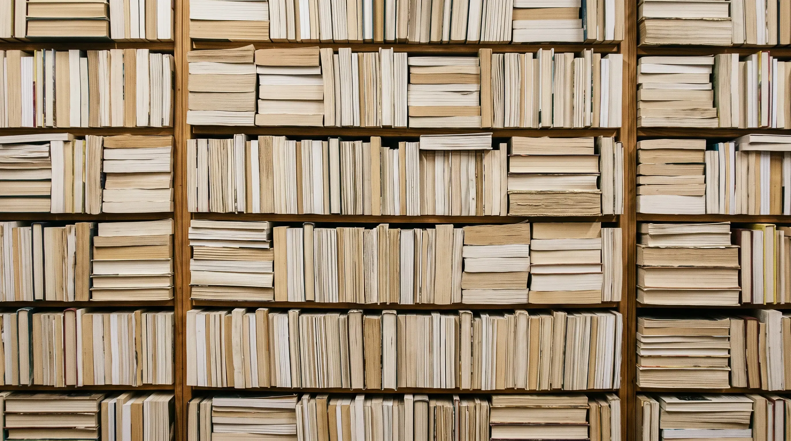 A library wall of books with their spines hidden