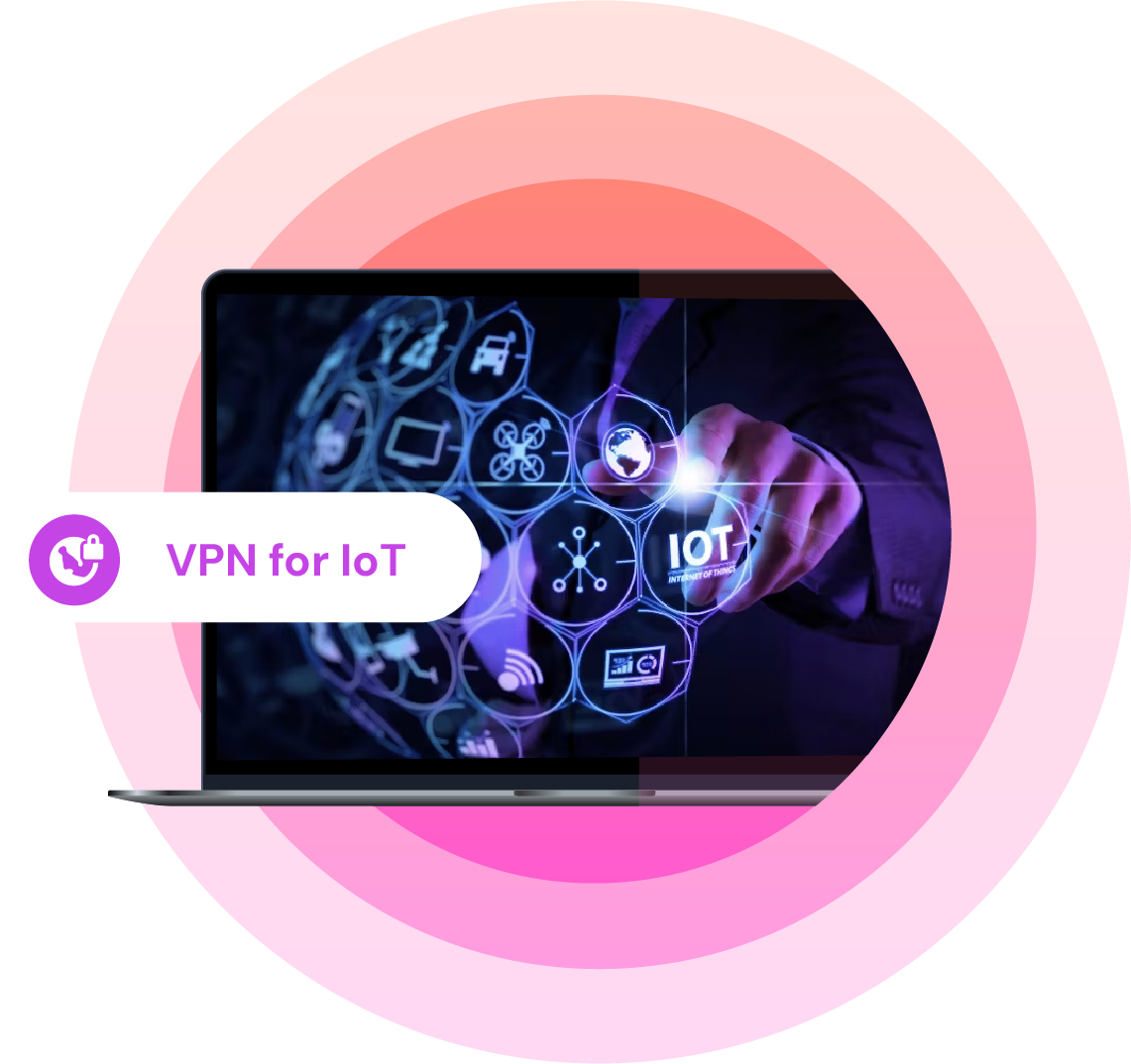 Laptop screen showing a person interacting with a virtual interface labeled “IoT” surrounded by icons representing Internet of Things devices; overlay text reads “VPN for IoT” with a shield and lock icon on a gradient pink background.