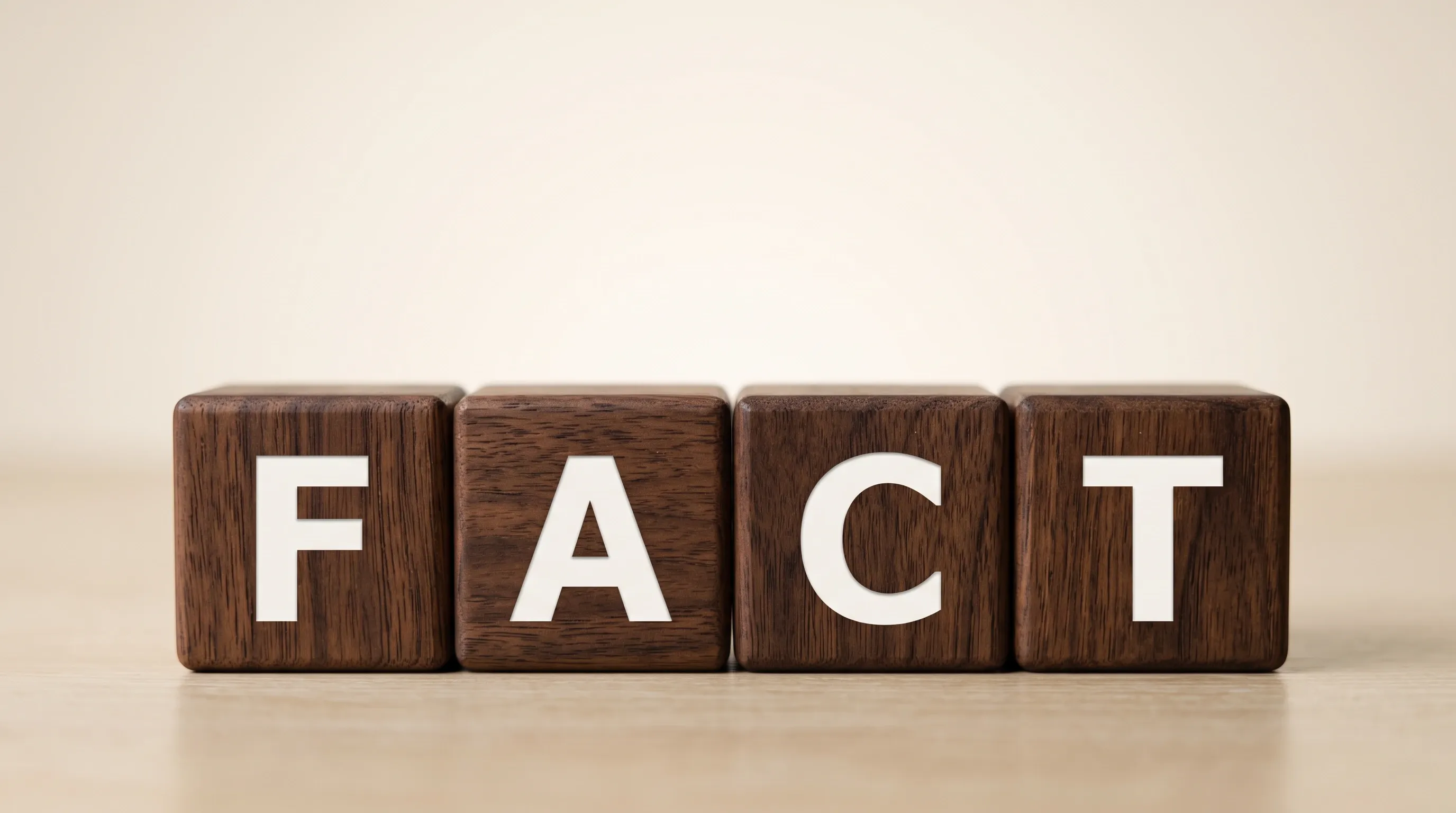 An image showing dark wood blocks spelling out "fact" in white capital letters